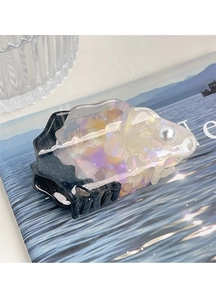 Close-up of a fish-shaped acetate hair claw clip with colorful textures and a pearl