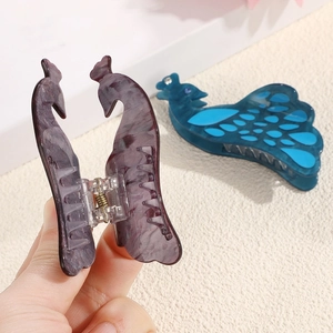 Elegant peacock-shaped acetate hair claw clips with marble texture for updo hairstyles