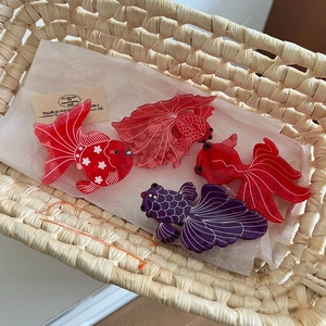 Elegant goldfish-shaped acetate hair claws in various vibrant colors for updos