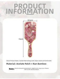 Detail view of pink marble acetate cushion hairbrush with bamboo handle and 15cm size specs