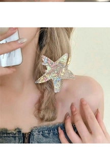 Detailed view of a holographic starfish hair claw clip with rhinestones on hair