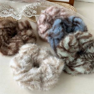 Plush faux fur zebra scrunchies in assorted pastel colors for elegant hair styling