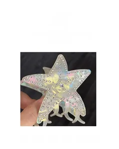 Macro shot of translucent starfish hair claw with colorful pearls and sparkling rhinestones