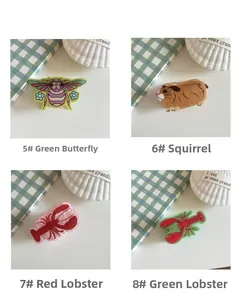 Detail view of animal hair claws featuring squirrel and lobster designs for styling