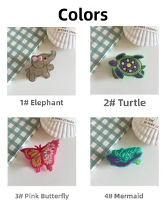 Detail of four acrylic animal claw clips featuring elephant, turtle, butterfly and mermaid