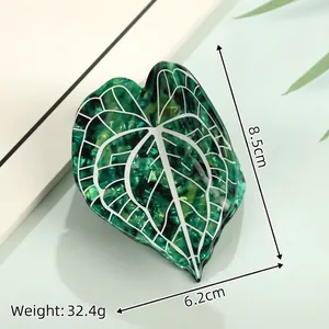 Leaf-shaped acetate hair claw with green marble texture, measures 8.5cm by 6.2cm, weight 32.4g
