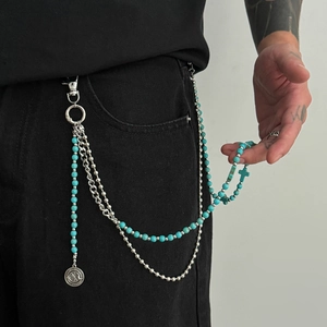 Detailed view of multilayer waist chain with turquoise beads and metal star pendant