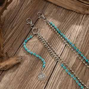Detail of high street hip hop pant chain with turquoise beads and round metal pendant