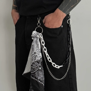 Detail of hip hop pants chain set featuring paisley bandana and layered metal ring chains
