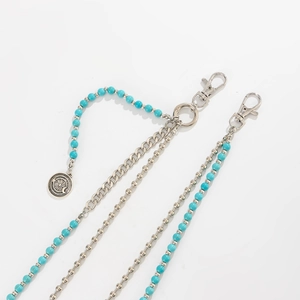 Detail of layered waist chain featuring turquoise beads and star-moon compass pendant