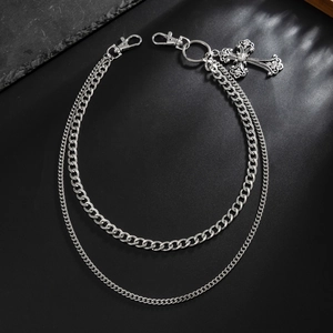 Close-up of double layer silver metal chains with gothic cross pendant and rhinestones