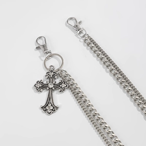 Detail view of gothic silver cross pendant with rhinestones on a double-layer metal pant chain