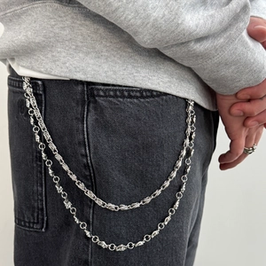 Detail of silver double-layered hip-hop pant chain with gothic cross engraved links