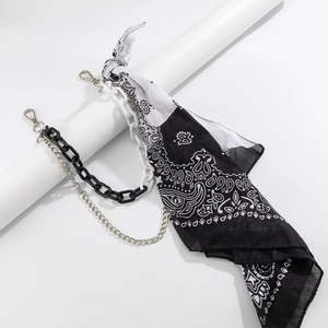 Detailed view of paisley bandana with chunky plastic and silver metal pants chains
