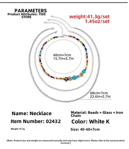 Detail view of multi-layered silver chains with colorful glass flower beads and rice beads