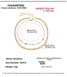 Detailed view of 33g gold Figaro chain and colorful faux pearl necklace set with crystals