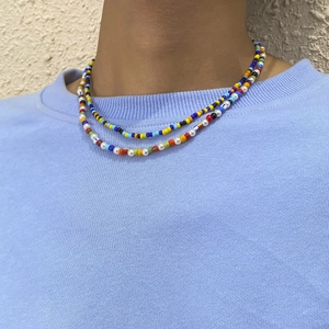 Close-up of a double-layered colorful bead necklace with imitation pearls on a model