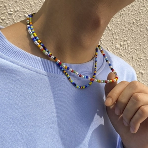 Close-up of bohemian layered beaded necklace with colorful seed beads and white pearls