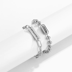 Silver metal industrial chain bracelet with rectangular Enchanted engraved charm tag