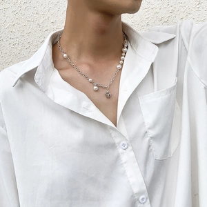 Men's minimalist pearl and silver chain necklace with a square dice pendant on model
