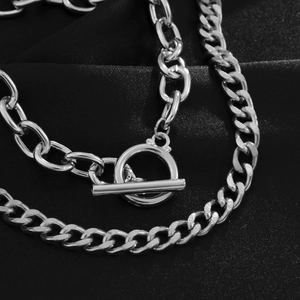 Close-up of a silver OT toggle clasp on a double-layer stainless steel chain bracelet
