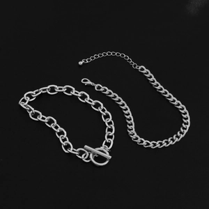 Detail of silver double-layered chain bracelet with toggle clasp and lobster buckle