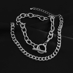 Detail of silver double-layered chain bracelet with toggle clasp on black silk background