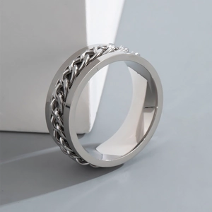 Close-up of hip-hop chain spinner ring in silver stainless steel on white pedestal