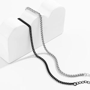 Detailed view of punk style black curb chain and silver box chain on display