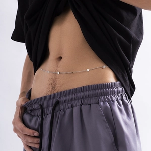 Detail of silver metal waist chain featuring round sequins on a minimal body link