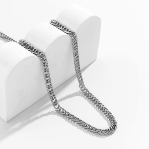 Minimalist punk style silver metal Cuban chain necklace with a polished industrial finish