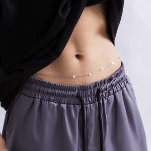Minimalist silver waist chain with hollow metal sequins shown on model body