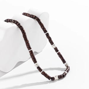 Detail of bohemian wood bead necklace with white spacers and silver metal accents