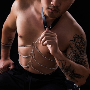 Macro shot of layered metal body chains and faux leather choker with three O-ring connectors