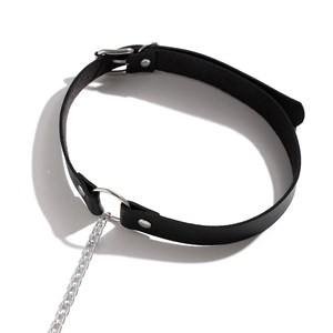 Close-up of black punk PU leather choker with silver metal ring and dangling chain detail