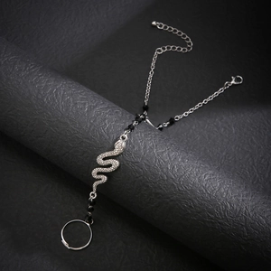 Gothic silver snake hand harness with black beads and adjustable ring on a prop