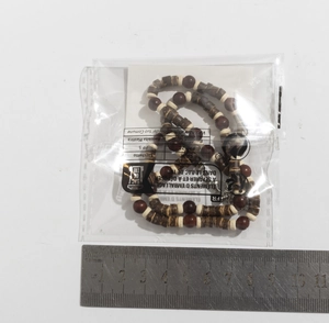 Detail view of Bohemian wood bead necklace showing dark brown round beads and flat spacers