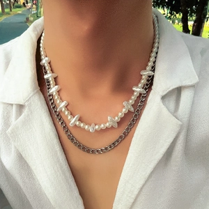 Close-up of double layer necklace with baroque pearls and silver curb chain on model