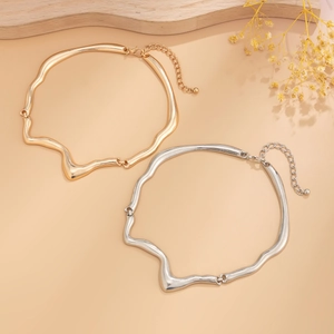 Detailed close-up of liquid metal lava necklaces in gold and silver with lobster clasp