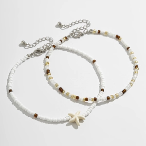 Detail view of bohemian beaded anklets with starfish charms and adjustable silver clasps