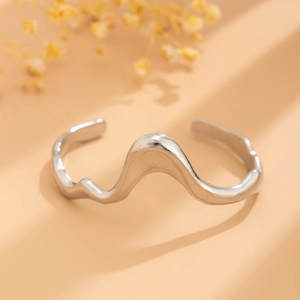 Macro shot of silver liquid metal wavy open choker with a polished mirror finish surface