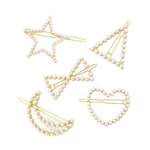 Close-up of a 5-piece gold hair clip set with pearls in star, heart, and moon shapes