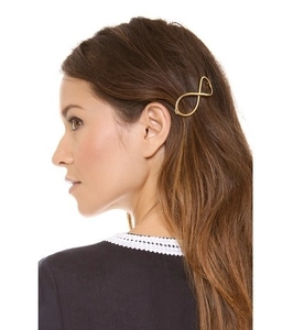 Golden infinity symbol hair clip styled on hair for an elegant minimalist look