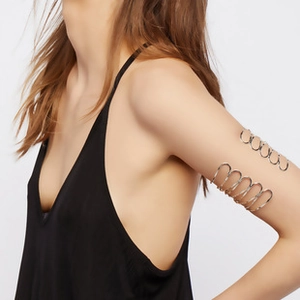 Close-up of a silver multi-layer hollow spiral leaf arm cuff on a model's upper arm