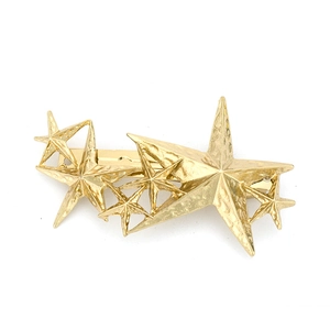 Golden 3D layered star hair clip with a textured hammered finish on white background