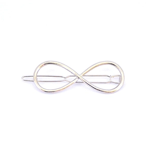 Detailed close-up of a silver infinity-shaped hair clip with a polished metallic finish