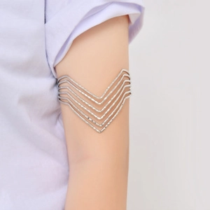 Detail view of a multi-layer V-shaped silver arm cuff on upper arm for women
