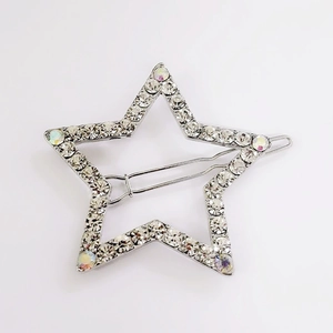 Stervormige geometrische haarspeld met witte strass op zilveren legering basis