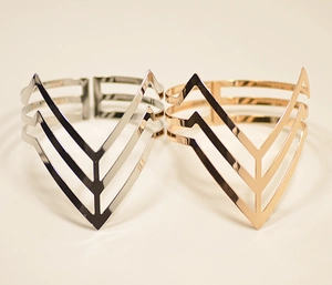 Detail view of triangular geometric open bracelets in polished silver and rose gold finishes