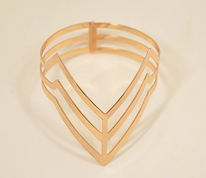 Detailed view of gold geometric V-shaped hollow open arm cuff bracelet with layered design